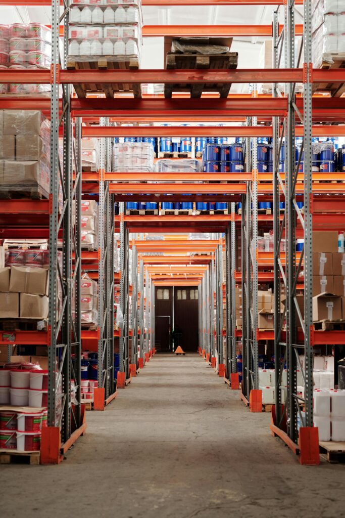 pexels photo 4483608 4483608 A modern warehouse interior showcasing organized shelves and pallets for efficient storage.