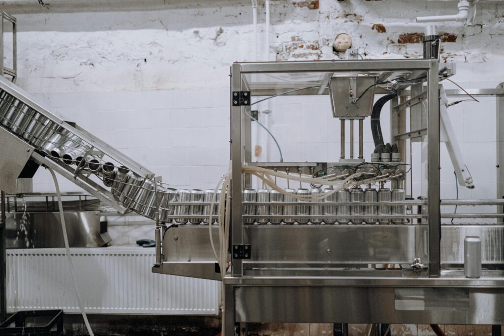 pexels photo 5532664 5532664 Automated beverage can packaging in a modern factory setting.